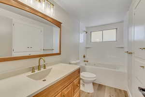 Full bath featuring vanity, light wood-style flooring, and shower / bathtub combination