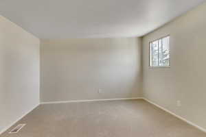 Carpeted bedroom with baseboards