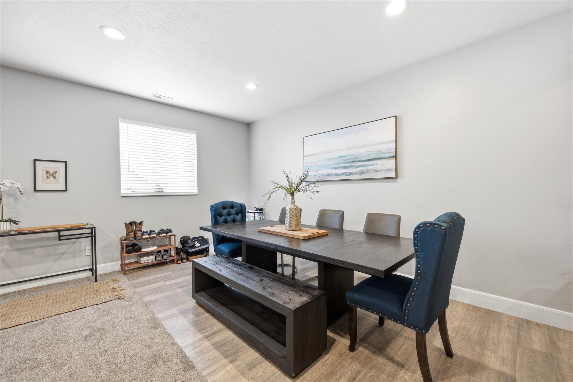 Dining room with light wood-style floors and recessed lighting