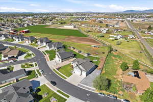 Aerial view of property and surrounding area with nearby suburban area