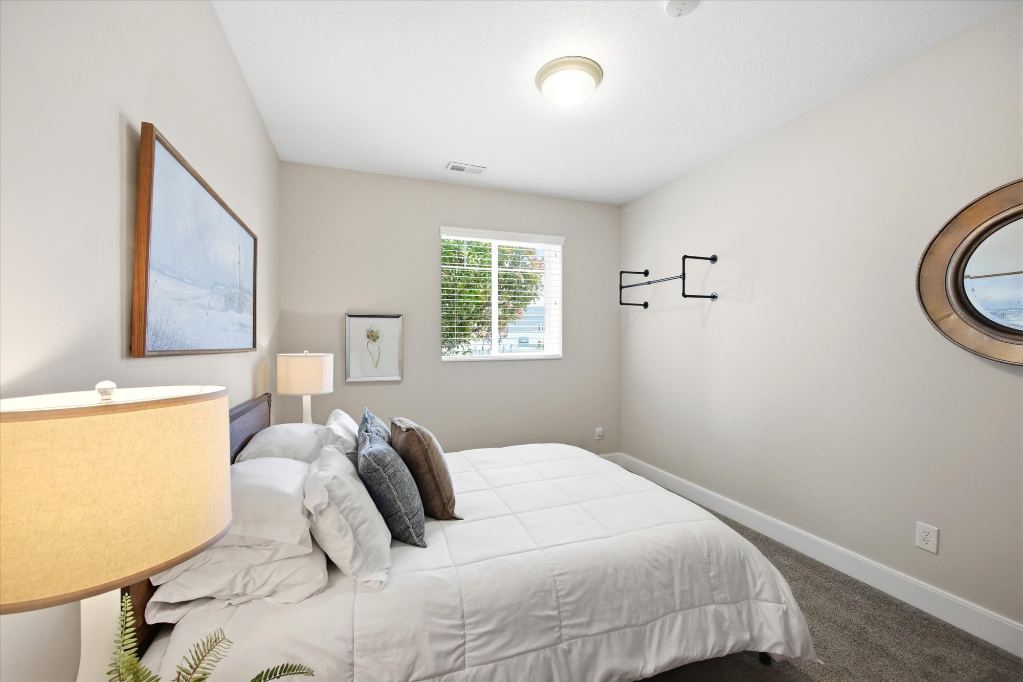 Bedroom featuring dark colored carpet and baseboards
