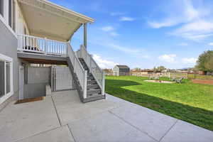 Fenced backyard featuring stairs and a patio