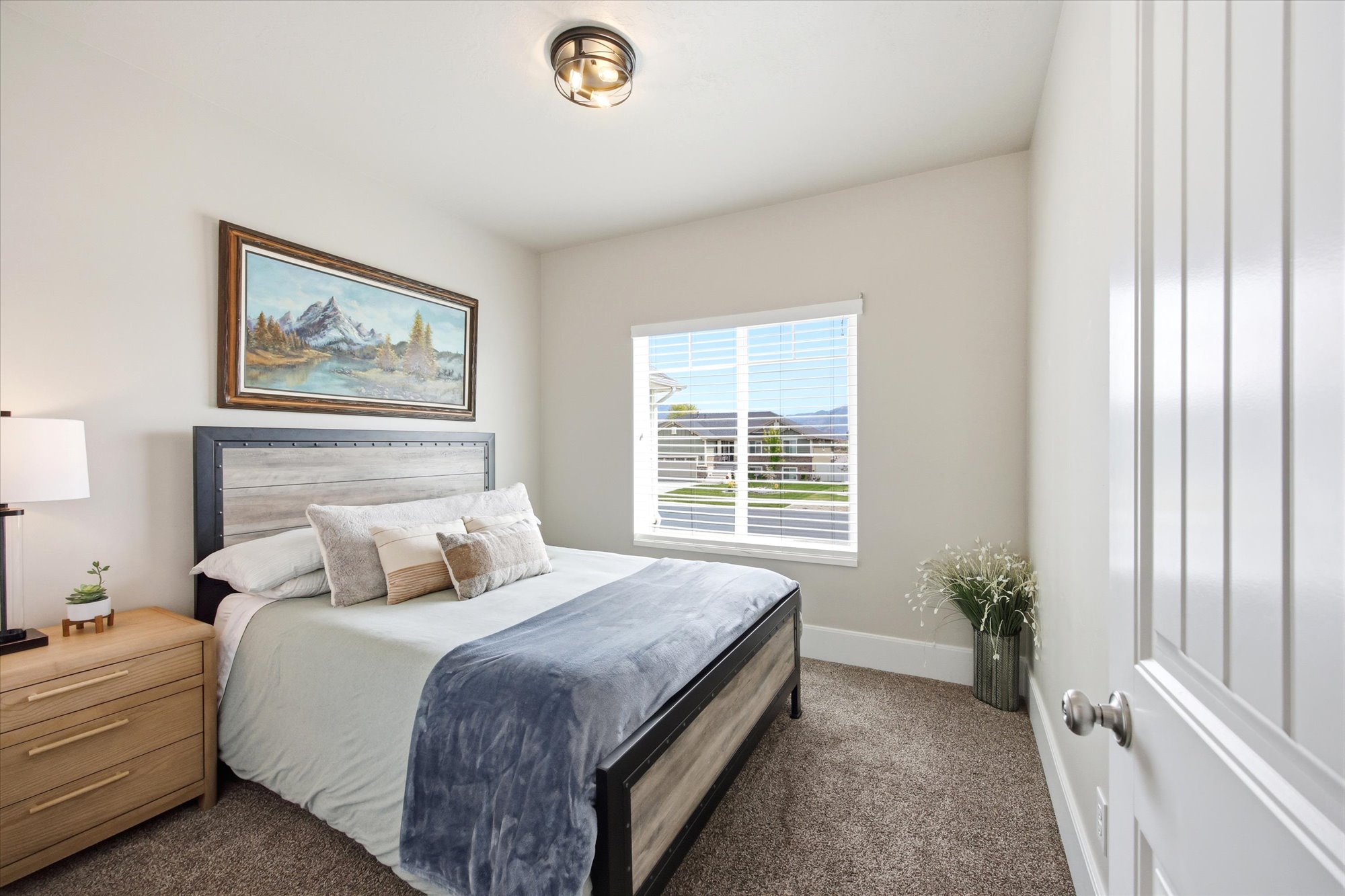 Bedroom with dark colored carpet and baseboards
