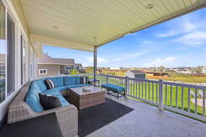 View of patio featuring a residential view, a shed, and outdoor furniture