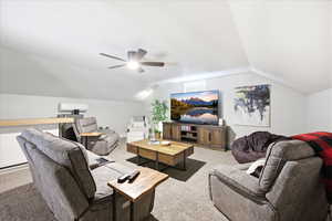 Living area with carpet flooring and a ceiling fan