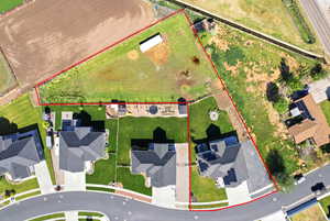 Aerial view of residential area featuring property boundaries highlighted