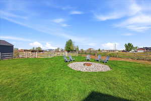 View of yard featuring an outdoor fire pit
