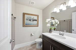 Bathroom featuring vanity and wood tiled floors