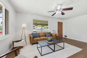 Living area featuring ceiling fan and wood finished floors
