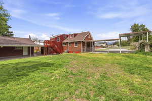 Rear view of house featuring a carport and brick siding