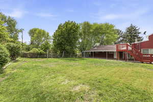 Fenced backyard with a patio and a deck