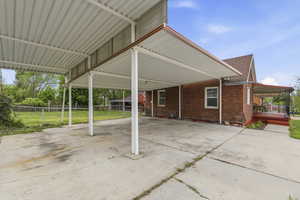 View of patio / terrace with an attached carport and driveway