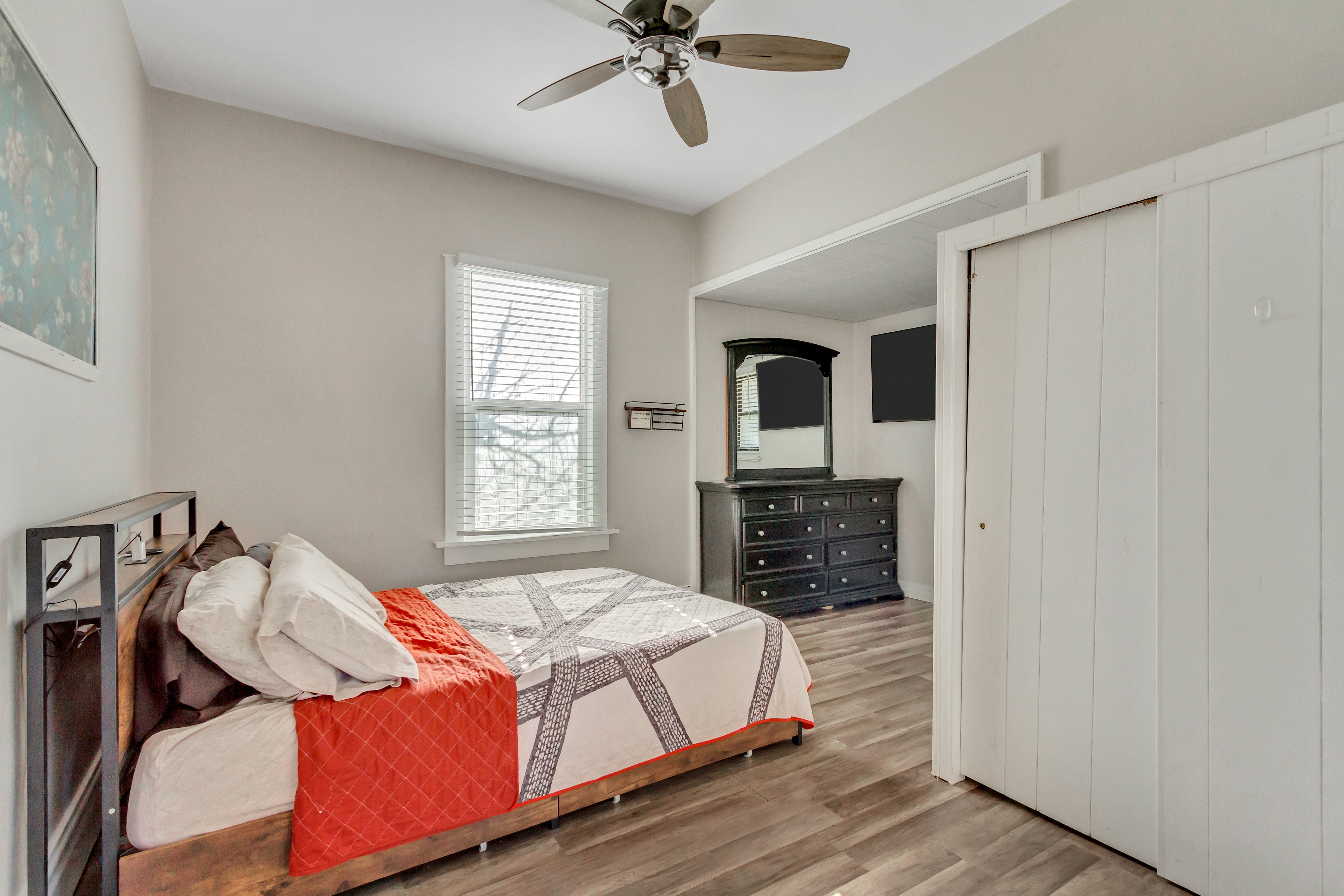 Bedroom 1 with wood finished floors, a ceiling fan, and a closet