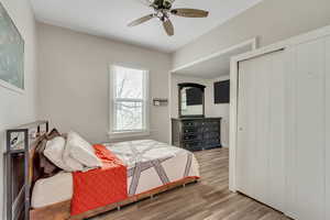 Bedroom 1 with wood finished floors, a ceiling fan, and a closet