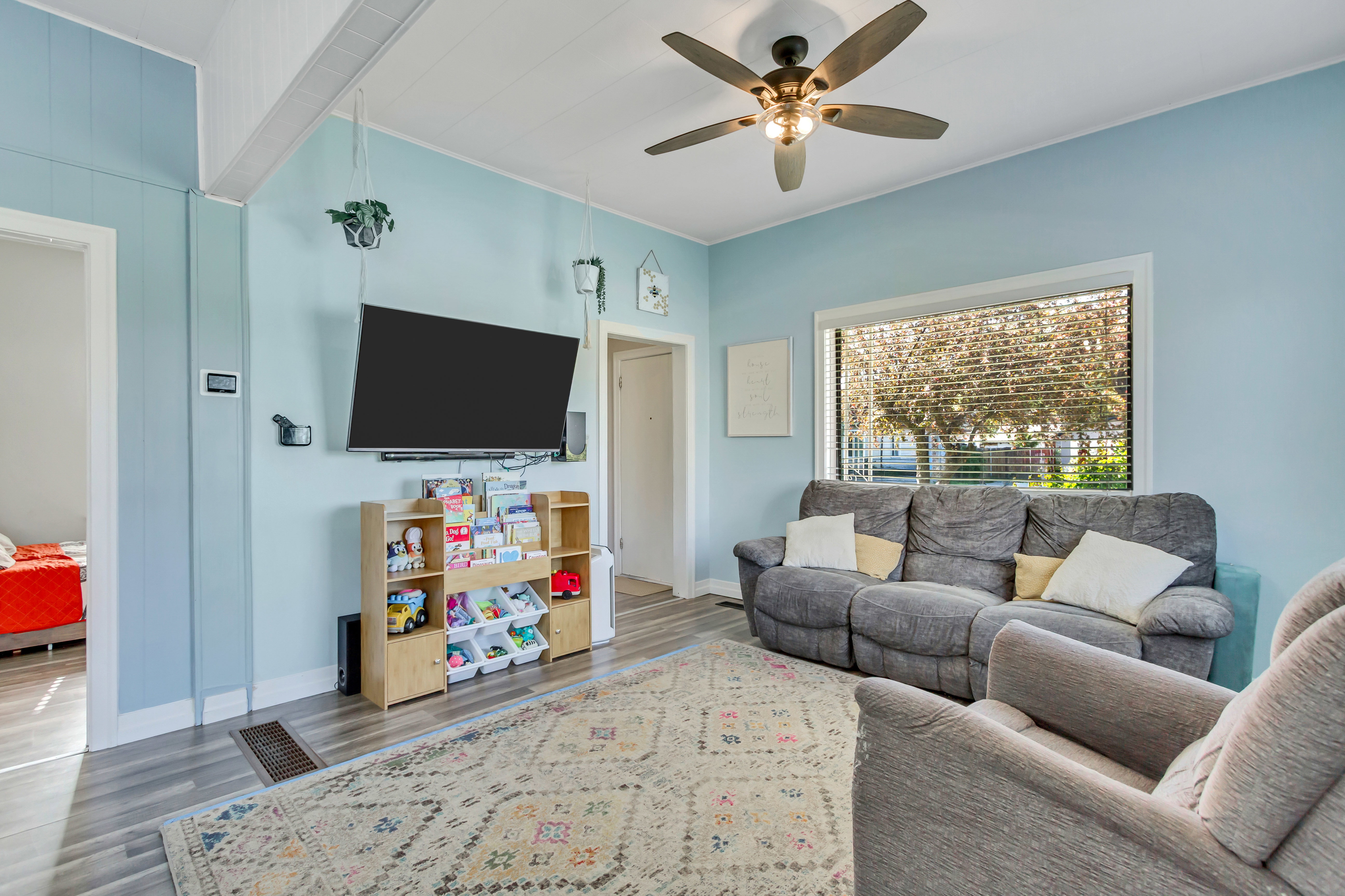 Living area with wood finished floors and a ceiling fan