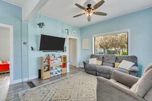Living area with wood finished floors and a ceiling fan