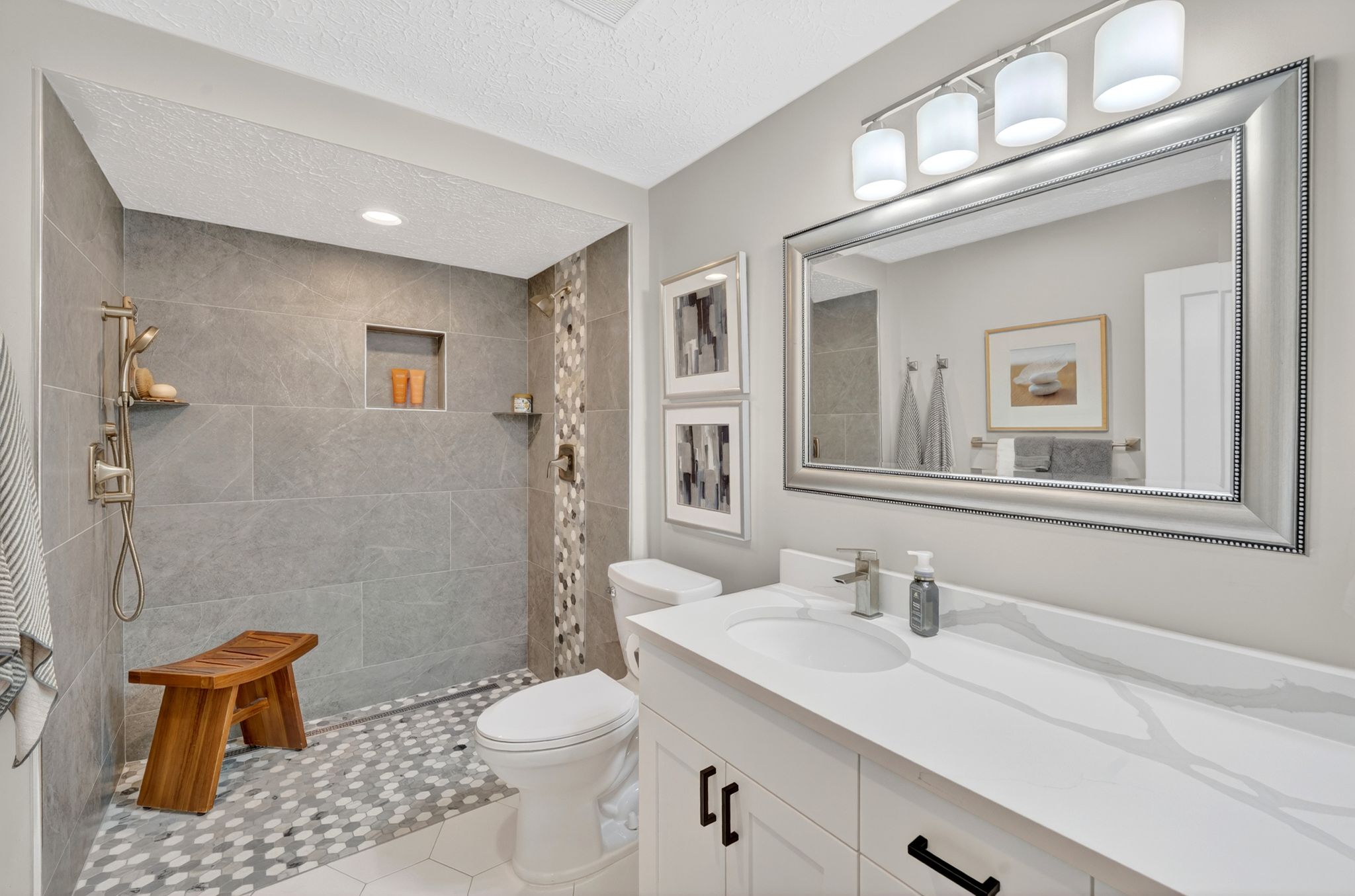 Full bathroom featuring vanity, walk in shower, and a textured ceiling