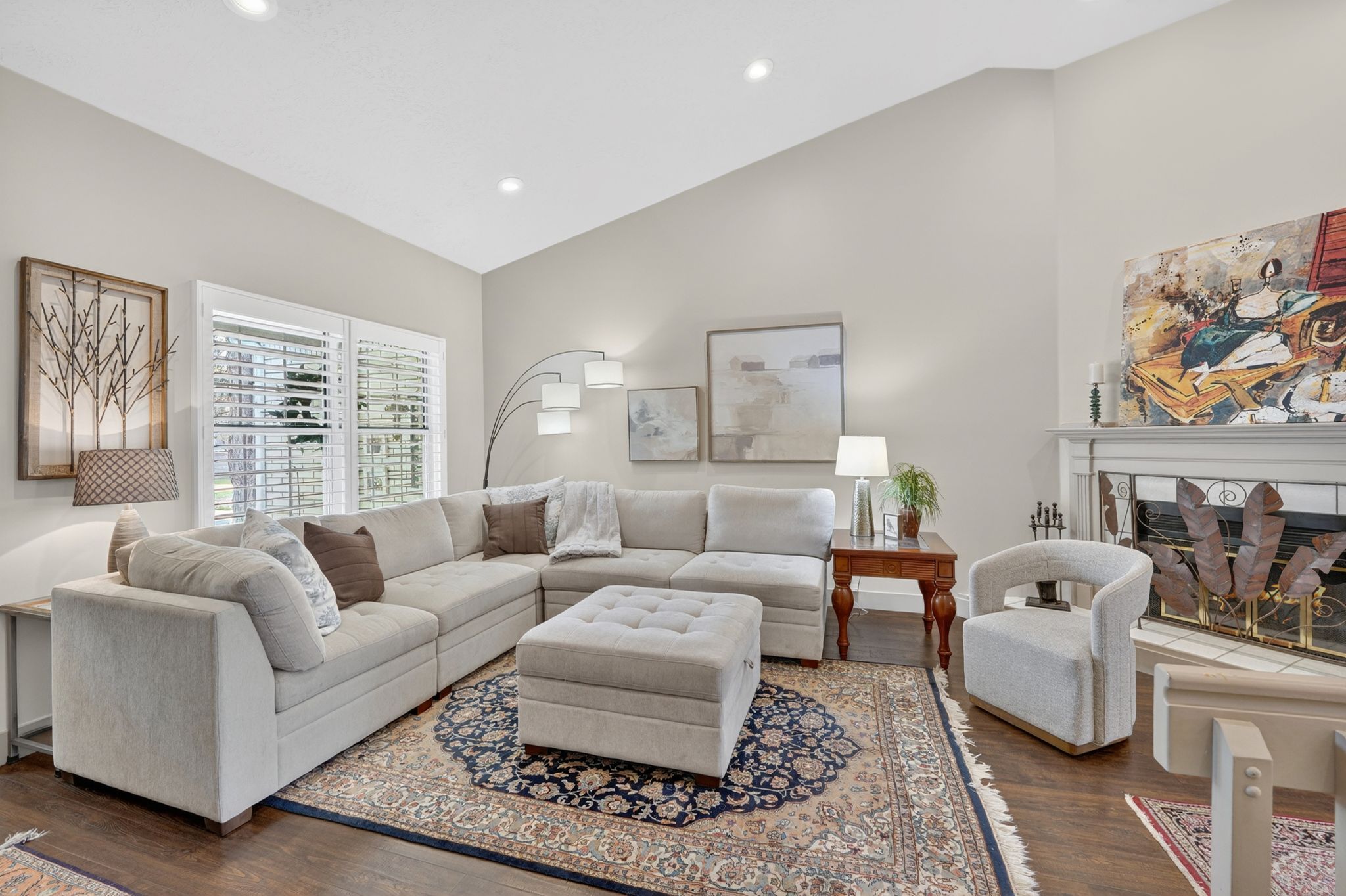 Living area featuring a fireplace, dark wood-style floors, vaulted ceiling, and recessed lighting