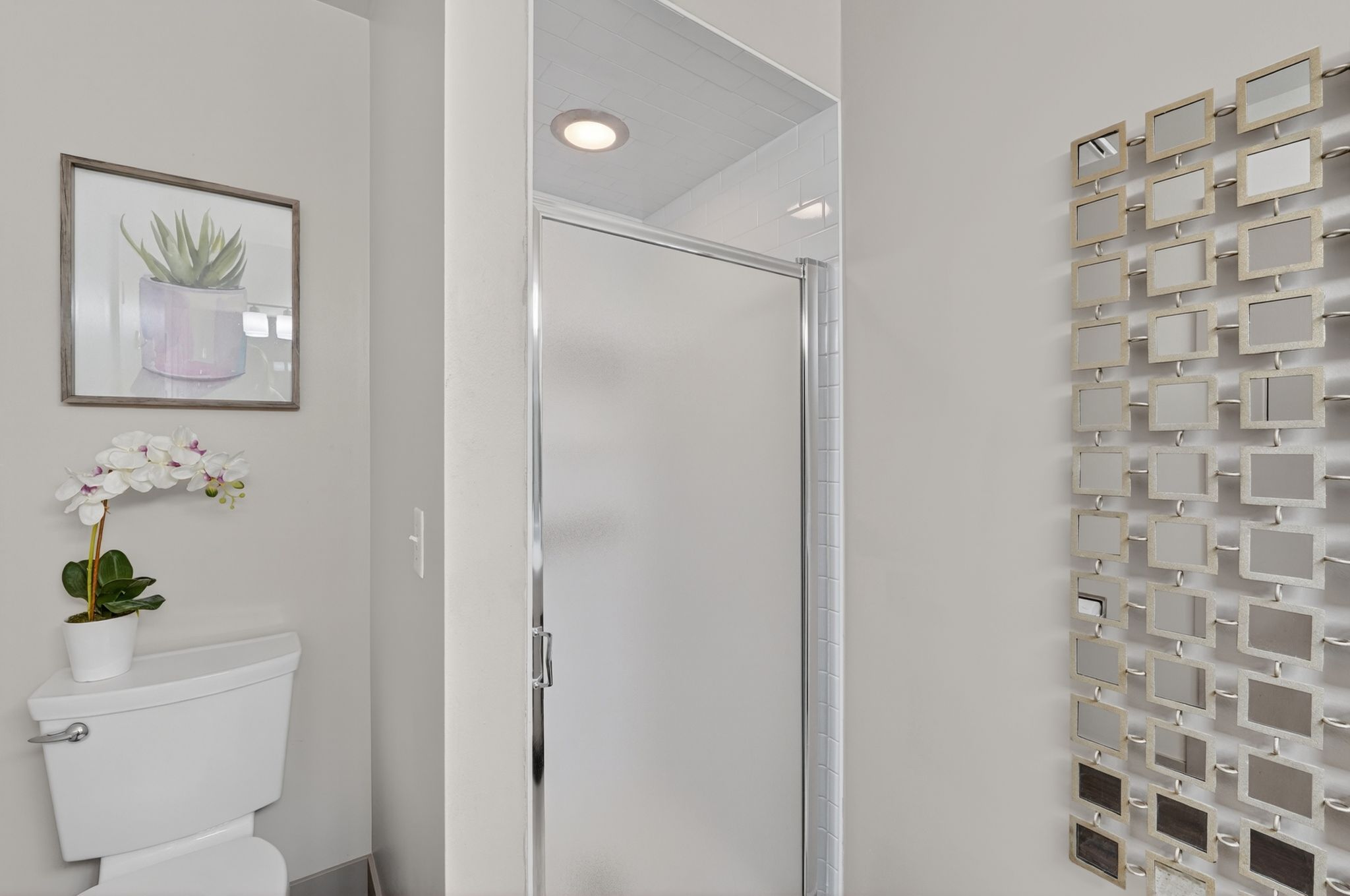 Bathroom featuring a shower stall and toilet