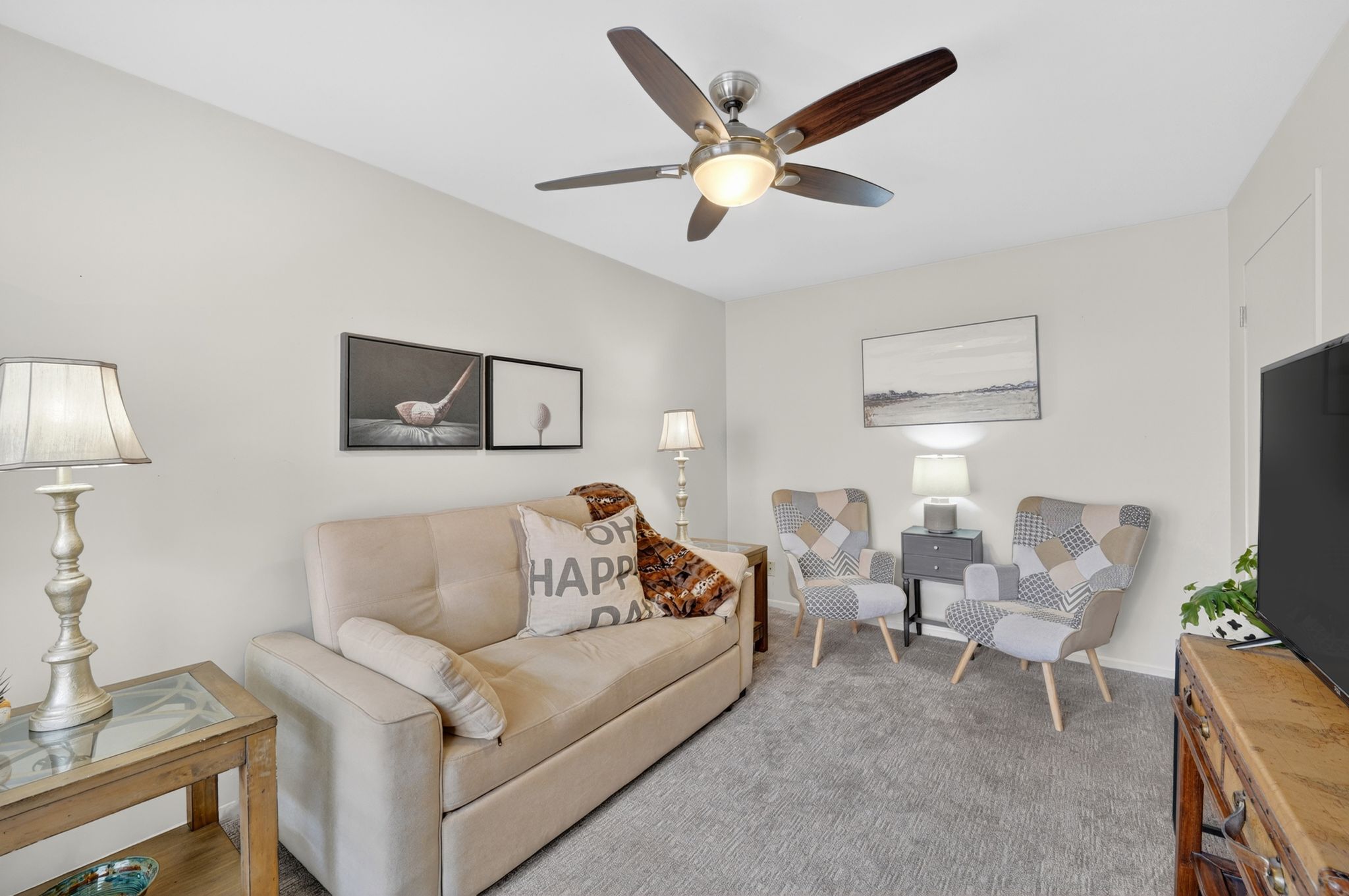 Living room featuring carpet flooring and ceiling fan