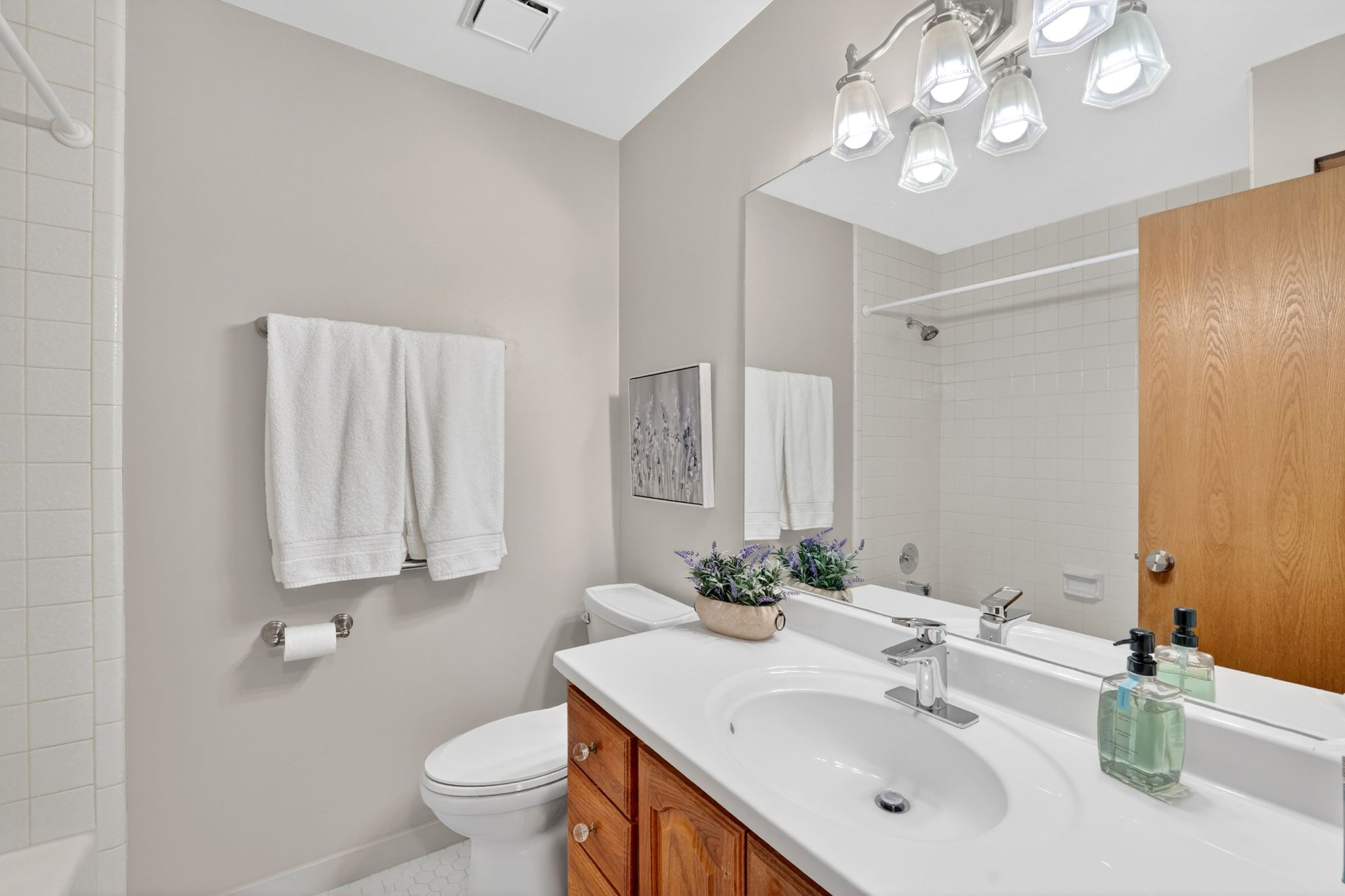 Bathroom with vanity and shower / tub combination