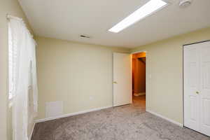 Unfurnished bedroom featuring carpet floors and a closet