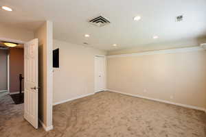 Unfurnished room featuring light carpet, recessed lighting, and a textured ceiling