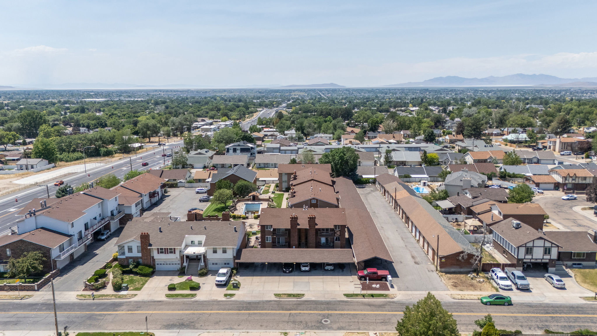 Expansive property featuring multiple residential structures and a long row of storage units