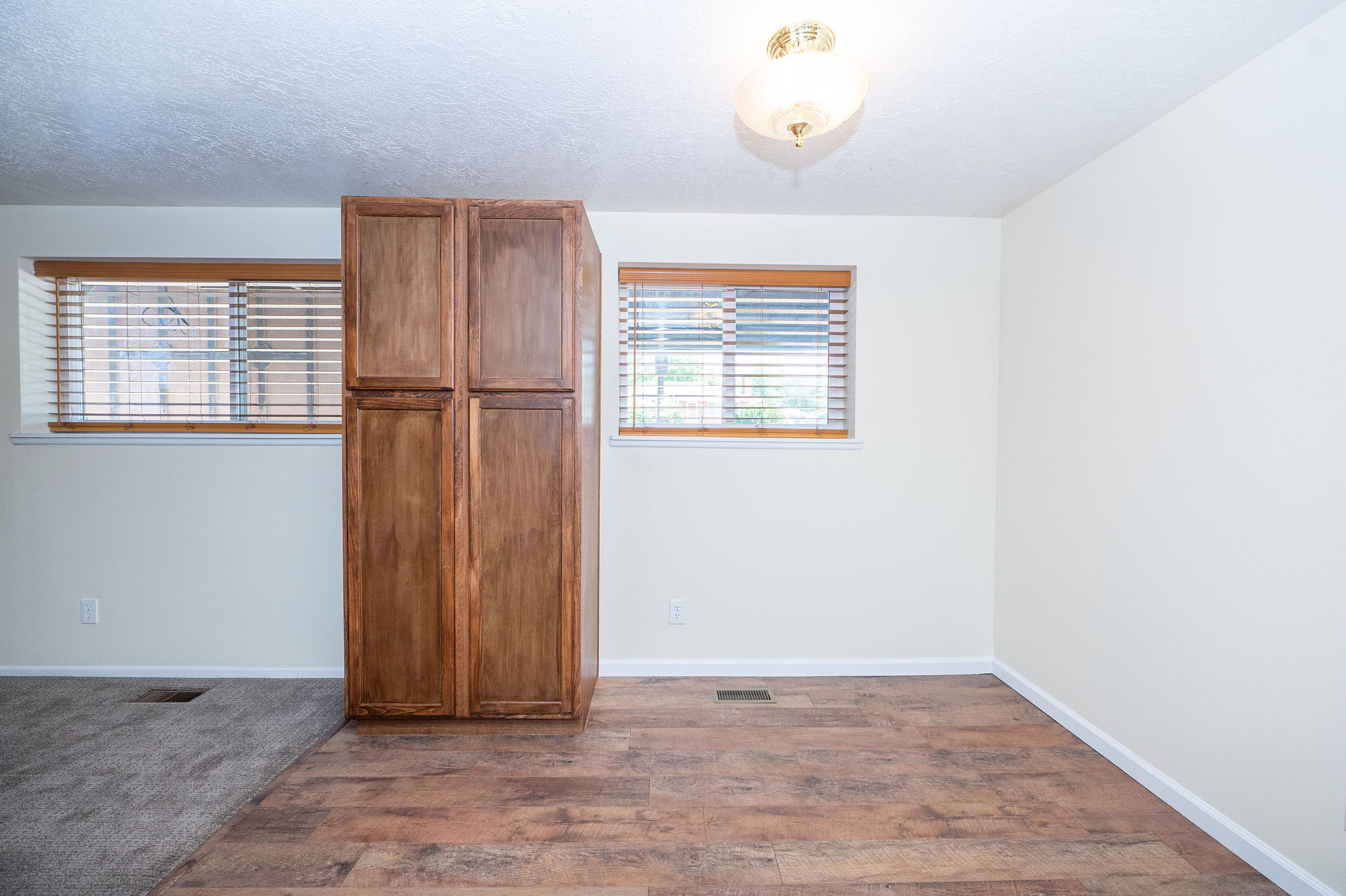 Built-in wood-finish cabinetry providing storage, complemented by warm wood-finish flooring