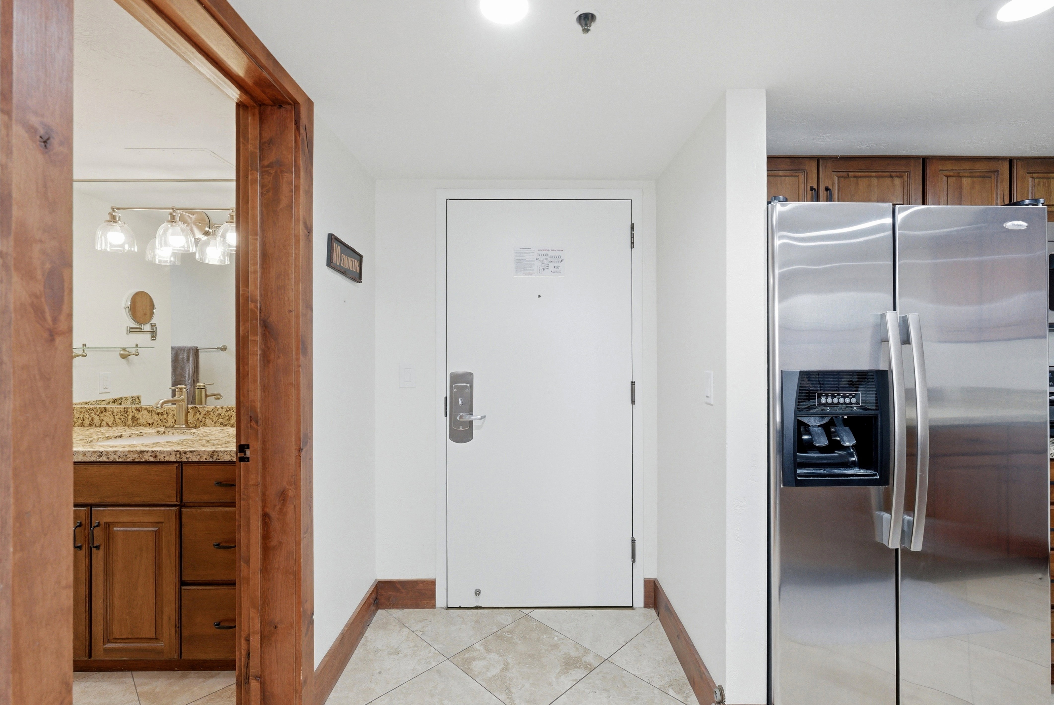 Doorway featuring tile patterned floors and baseboards