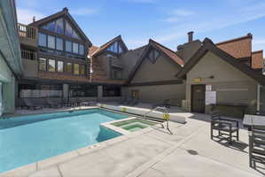 Integrated pool / hot tub featuring a patio