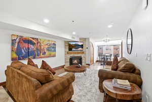 Living area with a fireplace and recessed lighting