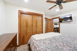 Carpeted bedroom featuring a closet, a ceiling fan, and recessed lighting