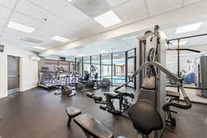 Exercise room featuring a paneled ceiling, a mini split for heating / cooling, and expansive windows
