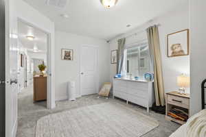 Bedroom featuring light carpet and baseboards