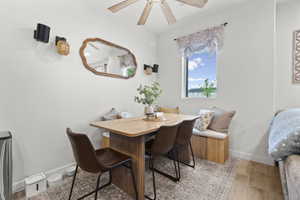 Dining room featuring breakfast area, light wood-style flooring, and a ceiling fan