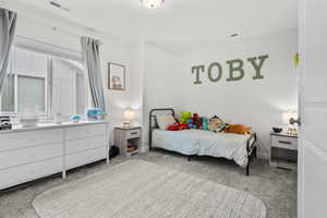 Bedroom featuring light colored carpet and baseboards