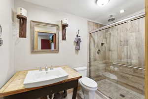 Full bathroom with a sink and a stall shower