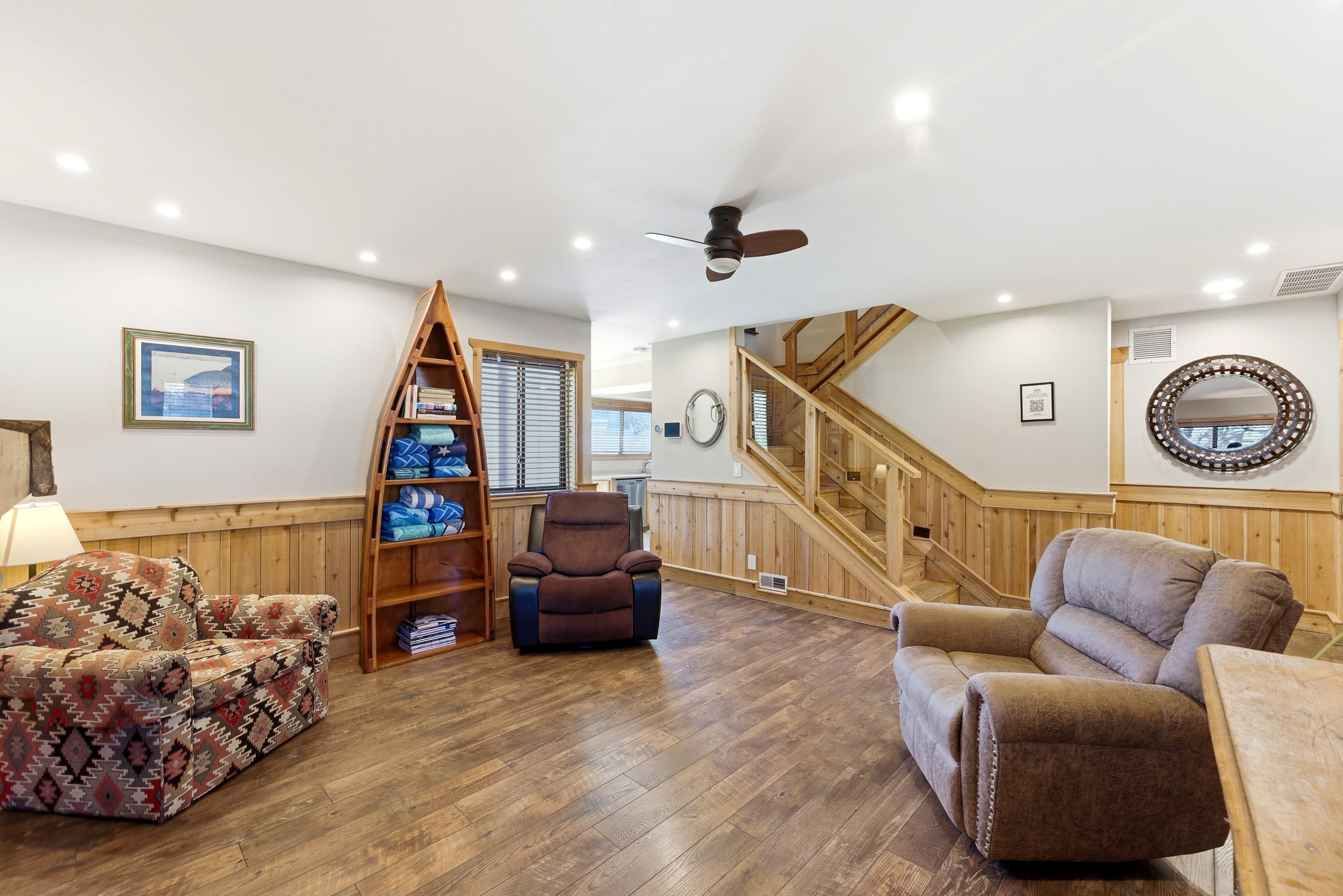 Living room with wainscoting, ceiling fan, hardwood / wood-style floors, wooden walls, and recessed lighting