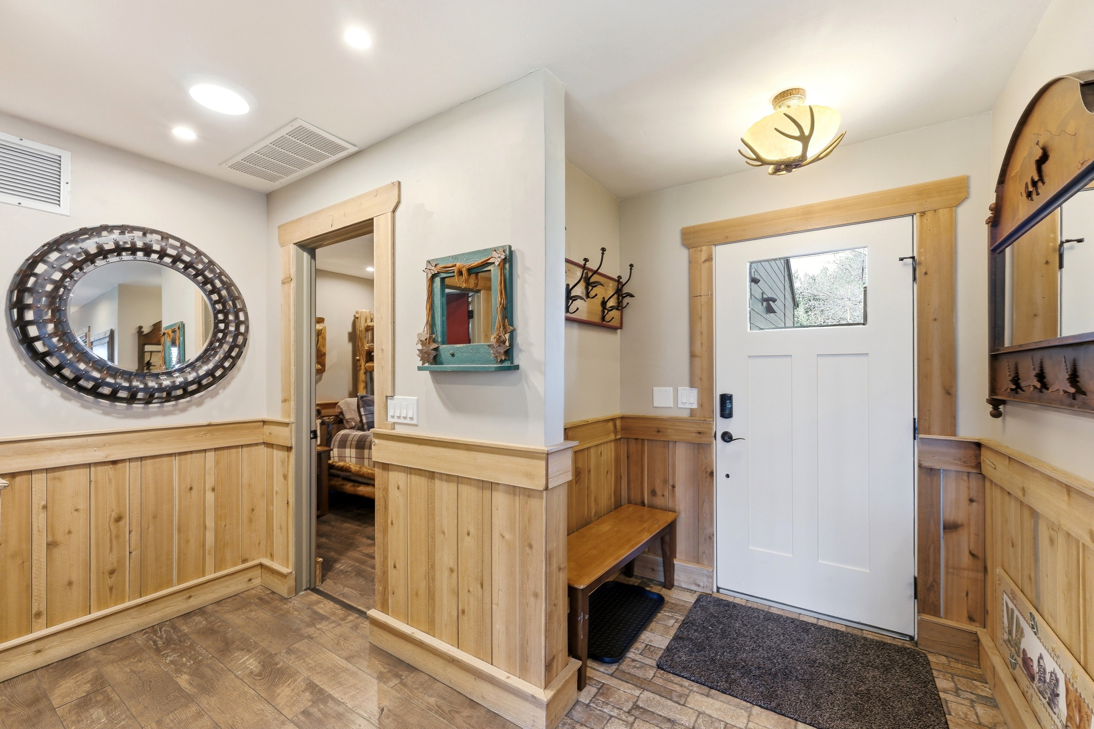 Foyer entrance featuring wood walls, wainscoting, wood-type flooring, and recessed lighting