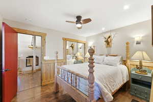 Bedroom with dark wood-style floors, a closet, and ceiling fan