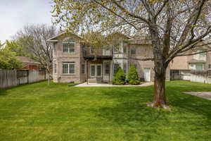 Back of house with a fenced backyard, brick siding, french doors, a patio, and entry steps
