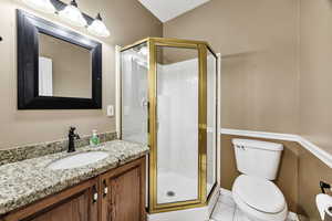 Full bathroom featuring vanity, a shower stall, and light tile patterned flooring