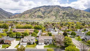 Aerial perspective of suburban area featuring a mountainous background