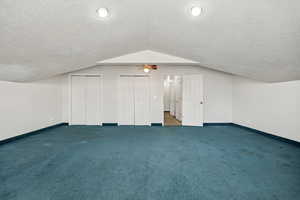 Additional living space with carpet and a textured ceiling