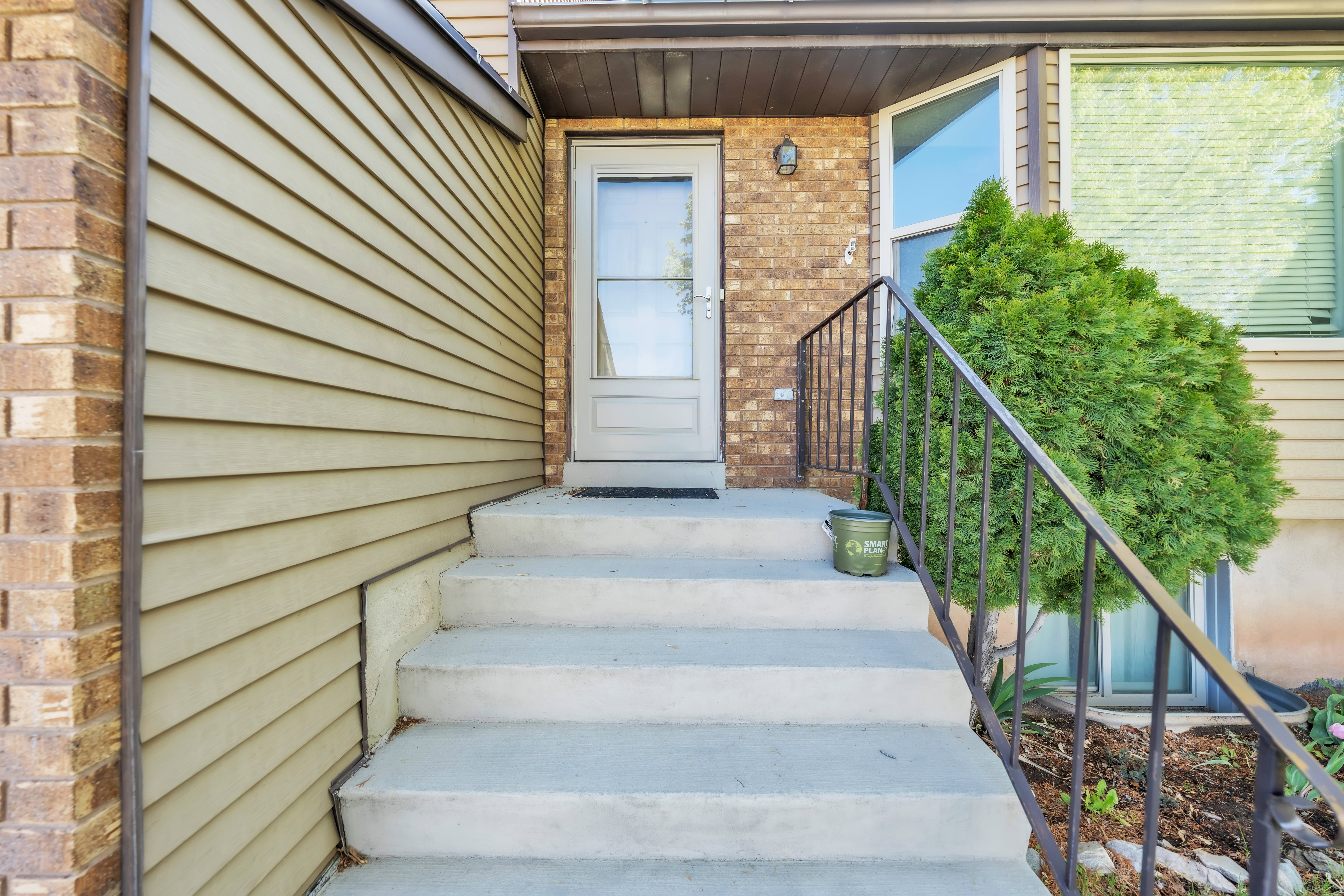 View of exterior entry with brick siding