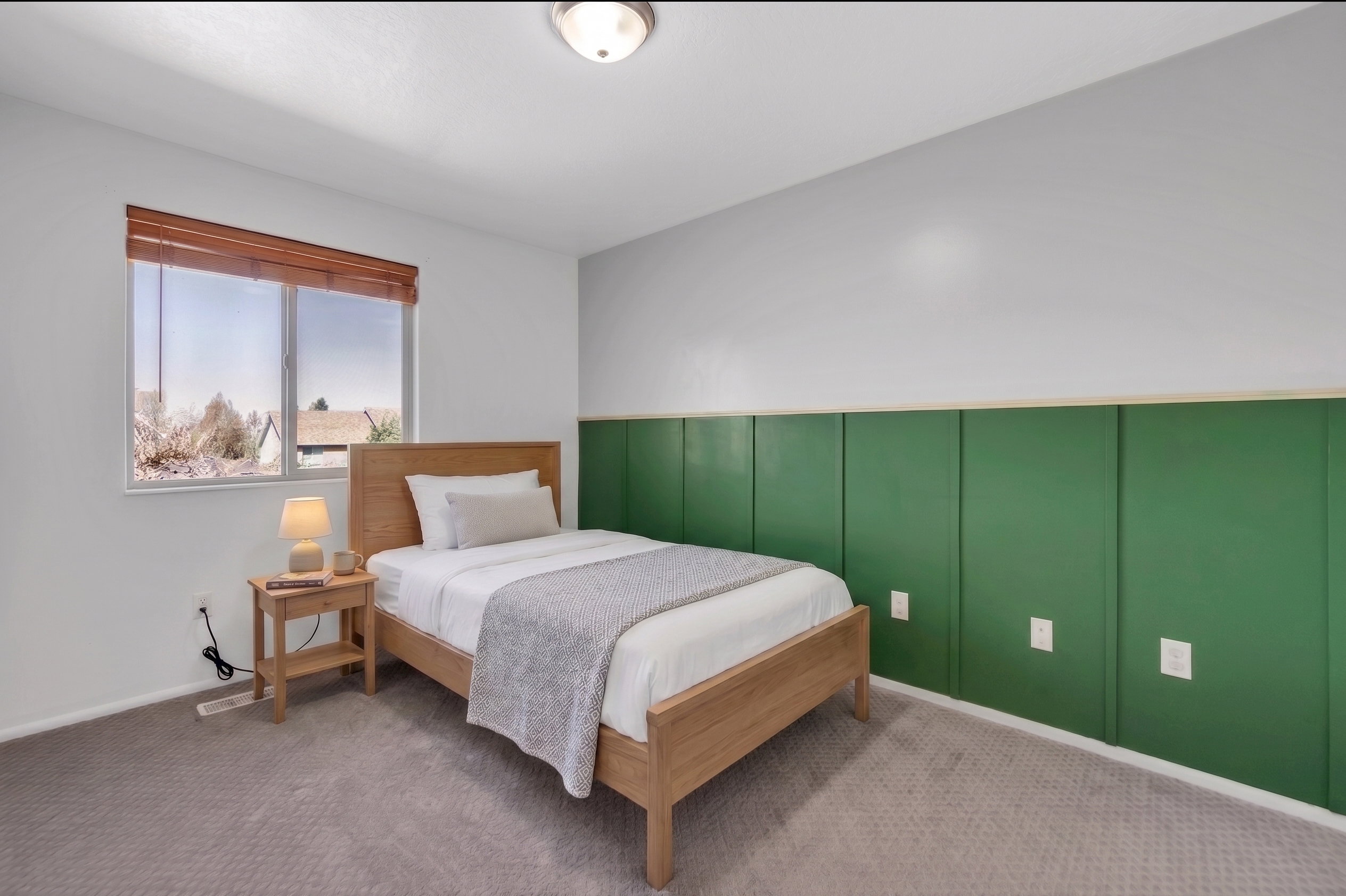 Bedroom with a decorative wall and carpet