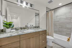 Full bath with recessed lighting, vanity, and shower / bath combination with curtain