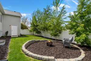 Fenced backyard featuring an outdoor fire pit
