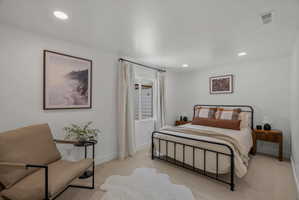 Bedroom with recessed lighting and light carpet